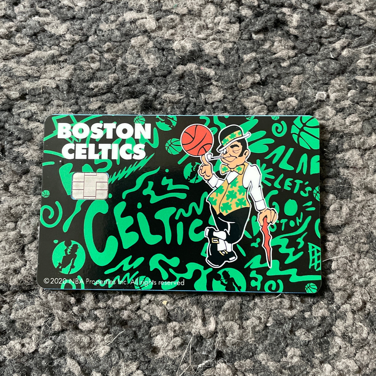 Customer showcasing their personalized nba boston celtics debit credit card skin