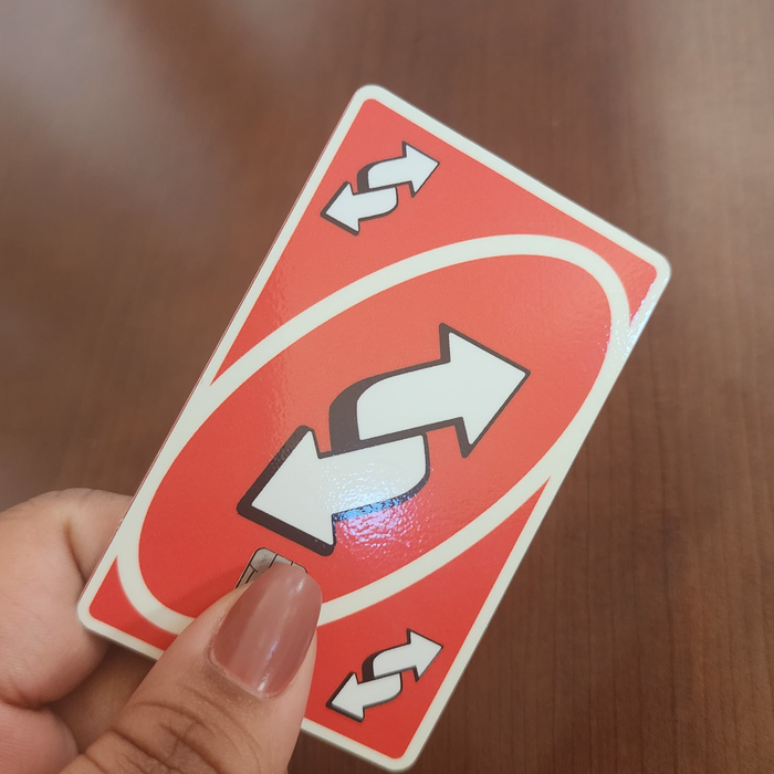 Customer showcasing their personalized Uno reverse debit credit card skin