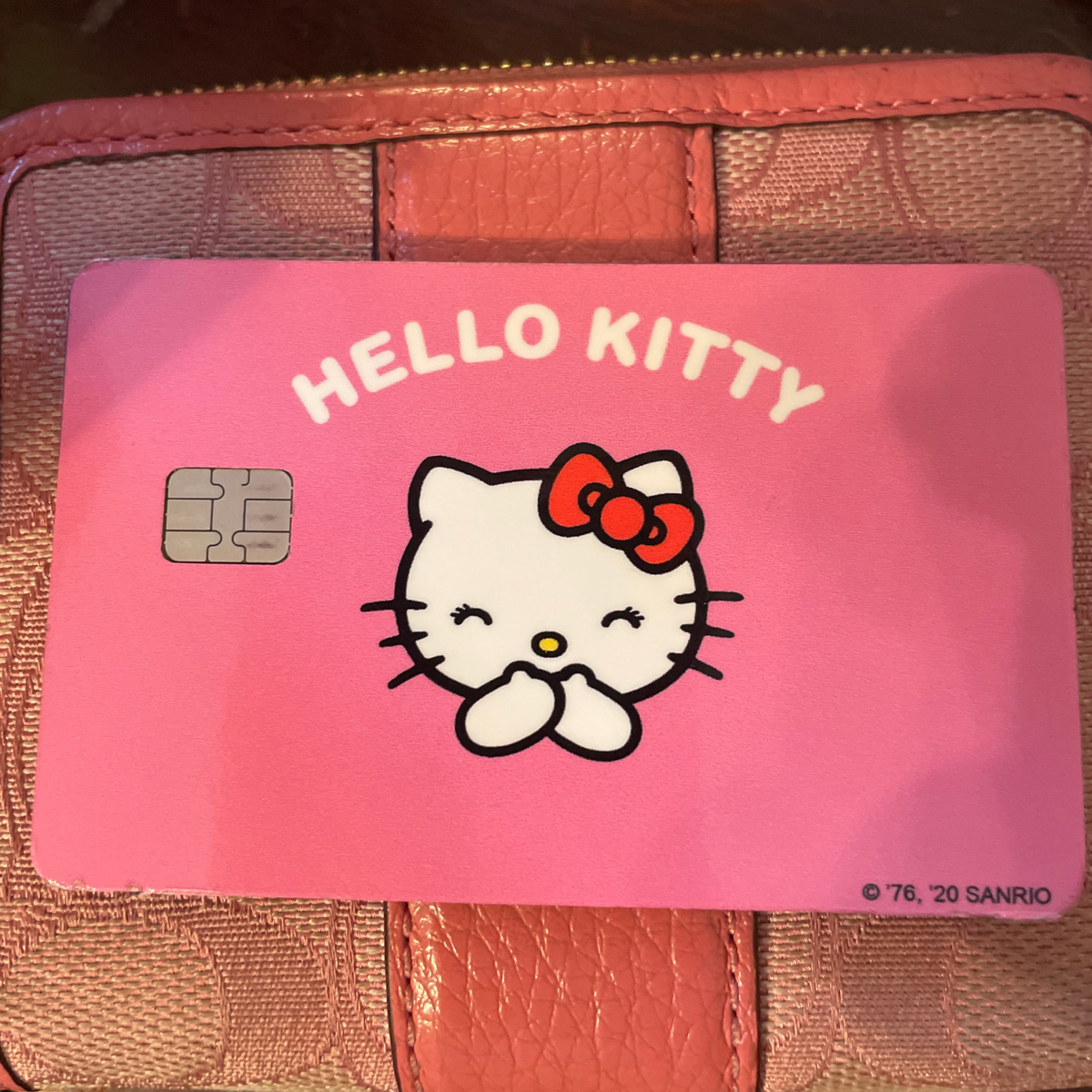 Customer showcasing their personalized hello kitty debit credit card skin